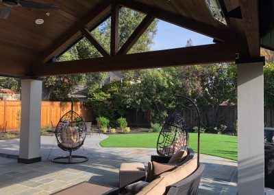 Santa Cruz House backyard landscaping and roofed patio with wood beams