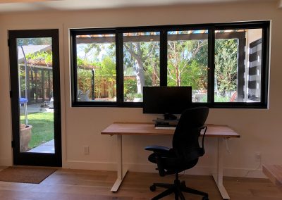 Willow ADU desk and windows with view of yard