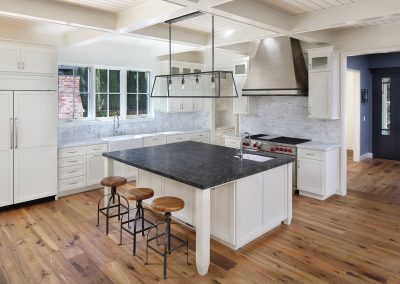 Creek House kitchen with white cabinets and gray tile backsplash